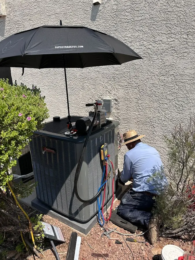 HVAC technician performing outdoor AC maintenance in Stonegate